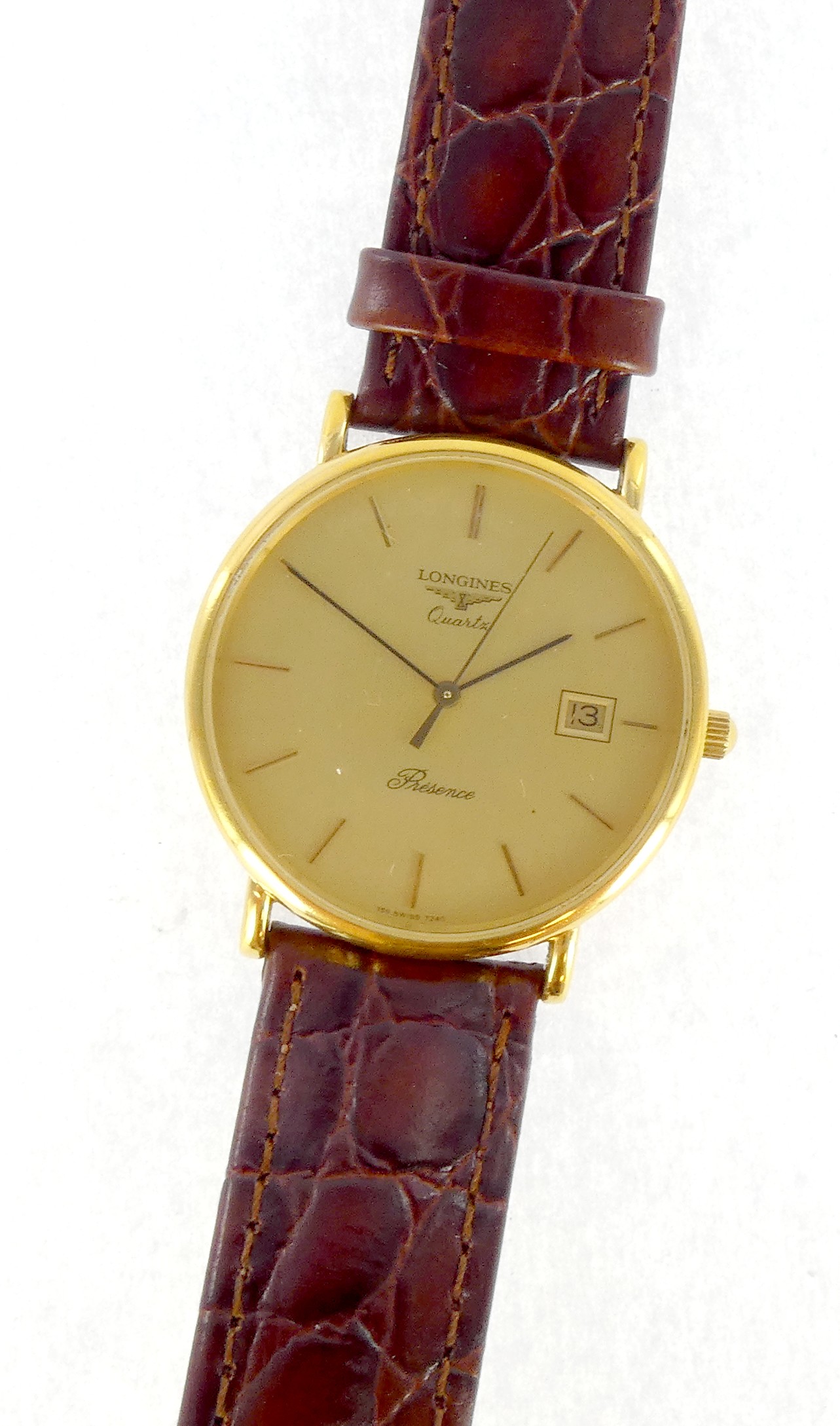 Lot 31 — LONGINES : Montre Acier, 38 mm, fond doré, date à 3h, sur br